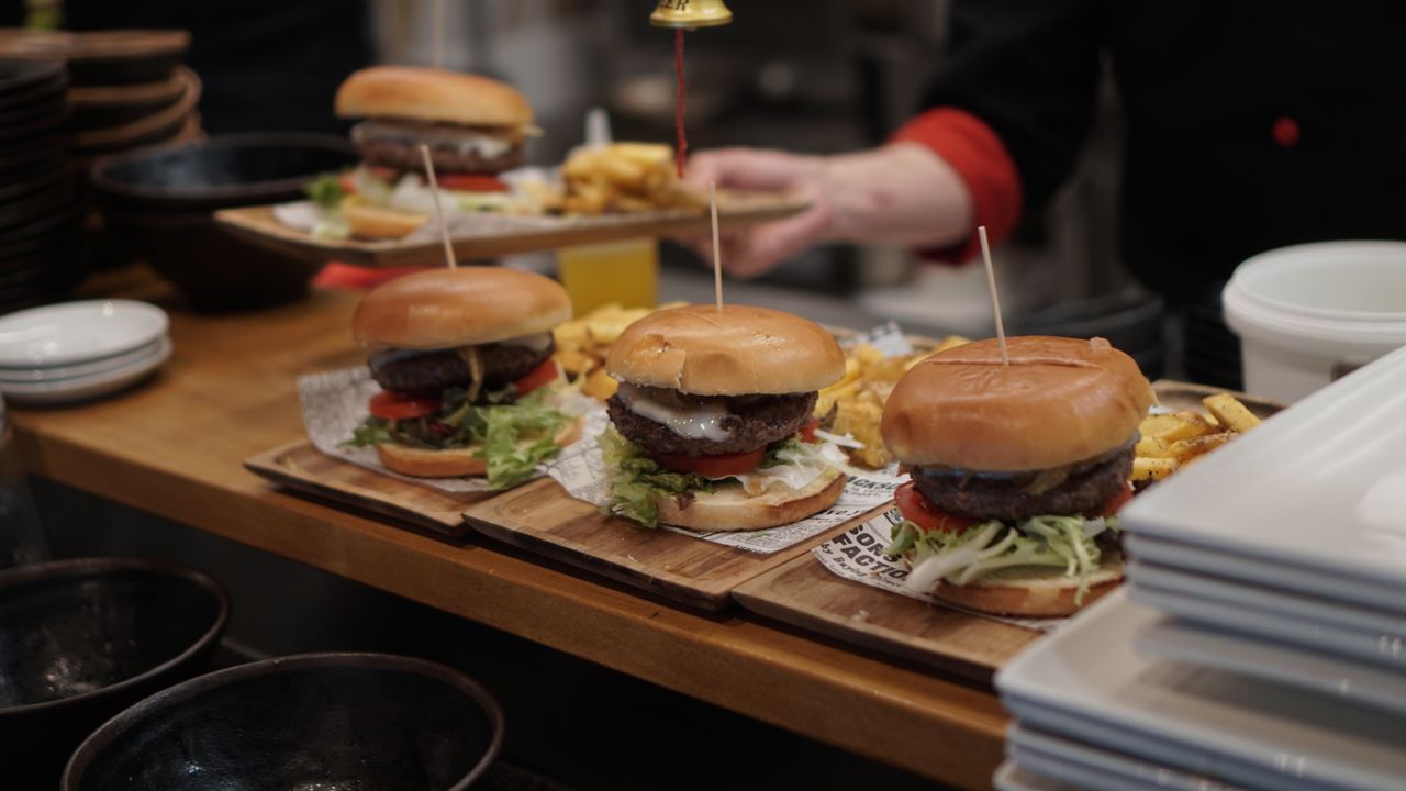 Mastering the First Impression: Your intriguing post title goes here Juicy gourmet burgers with fries ready to serve in a cozy restaurant setting.
